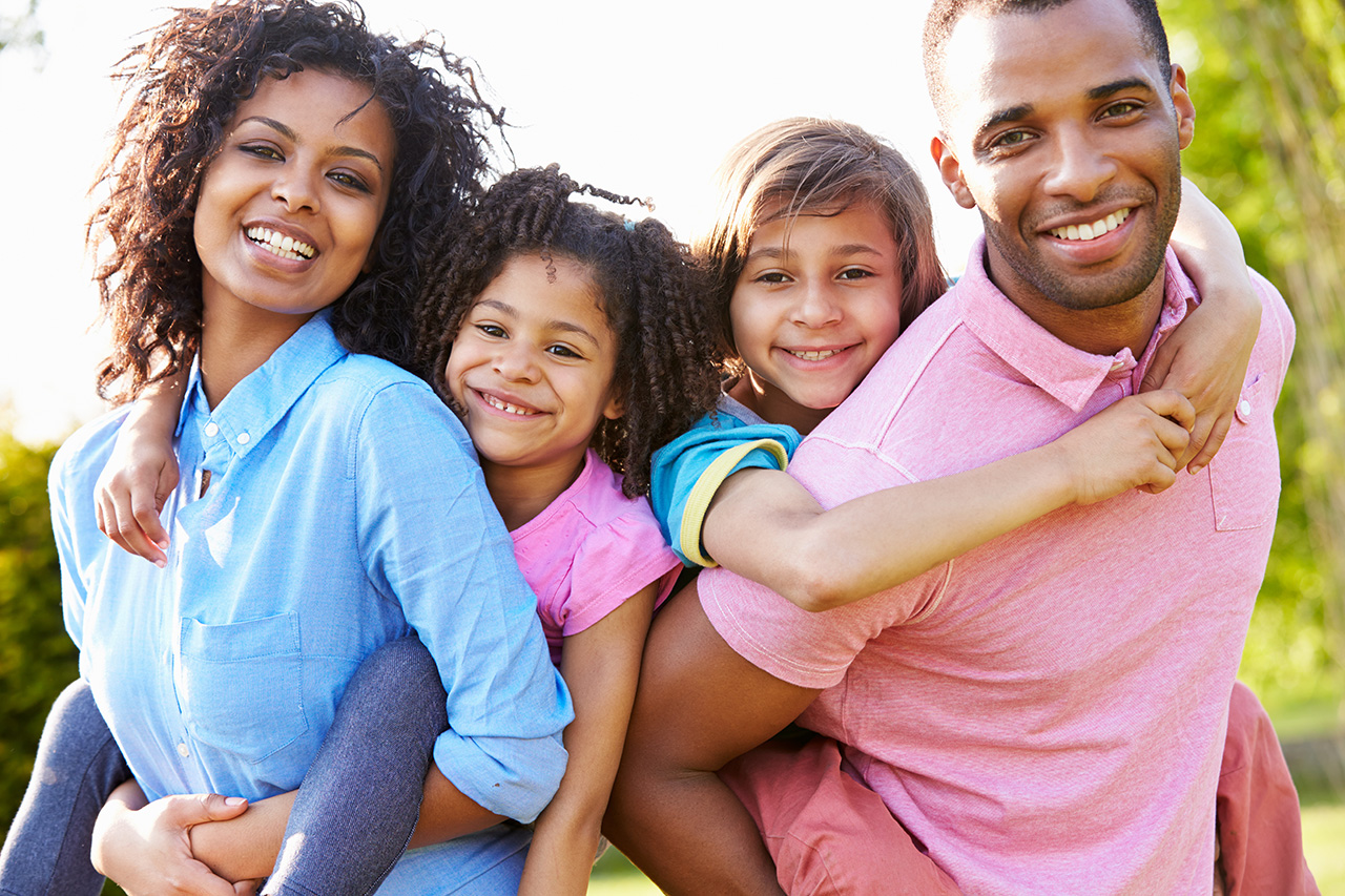 African American Parents Giving Children Piggyback Rides