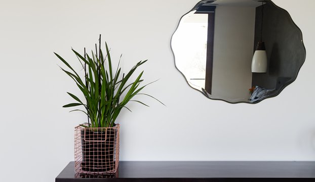 Home interior decor details copper wire basket and mirror in luxury bedroom